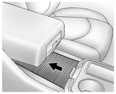 Additional storage compartment located under the center console armrest