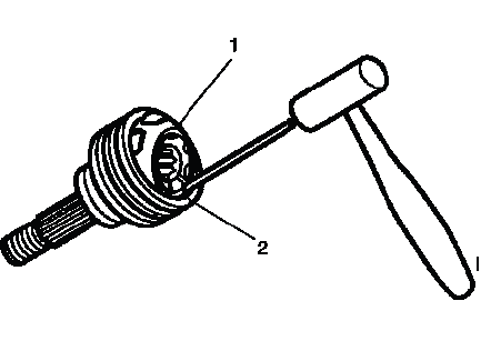 Gently tapping a brass drift to tilt the CV joint cage for ball removal